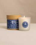 The front view of the We Took to the Woods And We Danced in the Sea Candle at Southern Tide - White