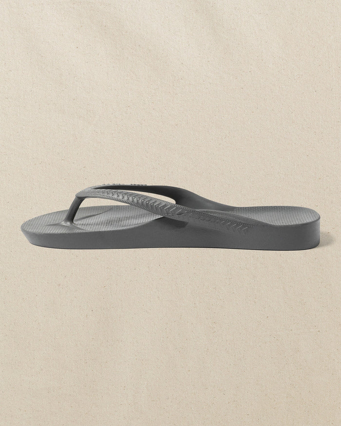 The left side view of the Southern Tide Archie's Charcoal Arch Support Flip Flop by Southern Tide - Charcoal