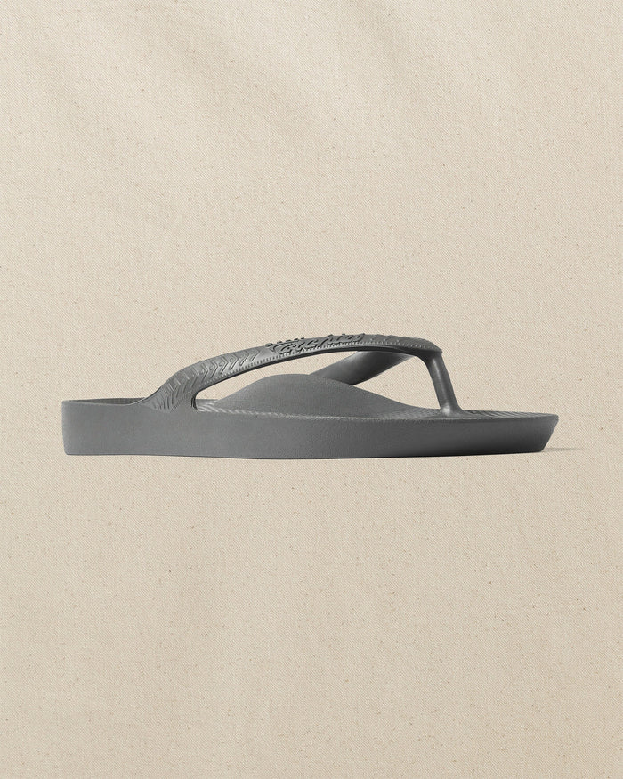 The front side view of the Southern Tide Archie's Charcoal Arch Support Flip Flop by Southern Tide - Charcoal