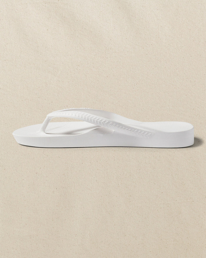 The left side view of the Southern Tide Archies Classic White Arch Support Flip Flop by Southern Tide - Classic White