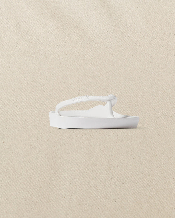 The front side view of the Southern Tide Archies Classic White Arch Support Flip Flop by Southern Tide - Classic White