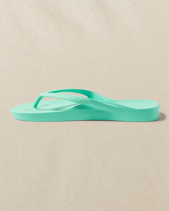 The left side view of the Southern Tide Archies Mint Arch Support Flip Flop by Southern Tide - Mint