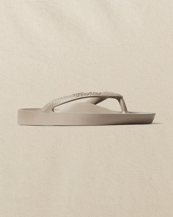The right angle view of the Southern Tide Archie's Taupe Arch Support Flip Flop by Southern Tide - Taupe