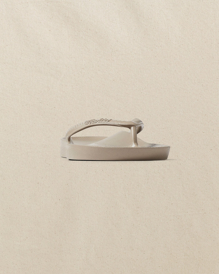 The front side view of the Southern Tide Archie's Taupe Arch Support Flip Flop by Southern Tide - Taupe