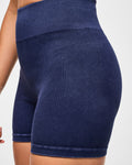 Close view of denim corduroy blue biker shorts shot on a white background.