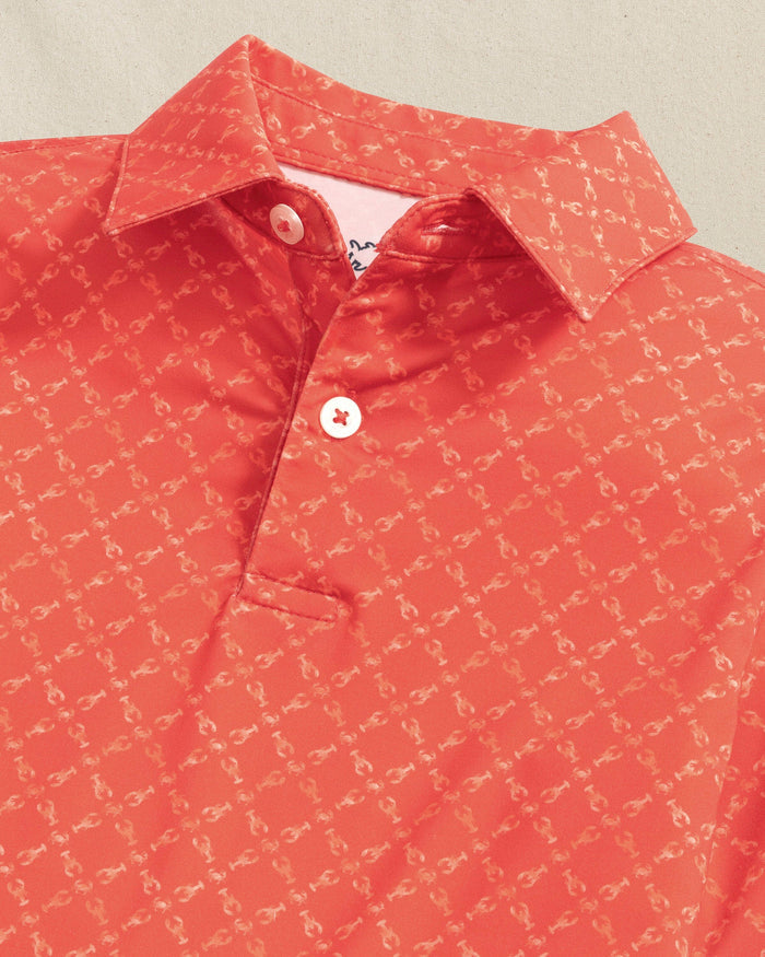 The detail view of the Southern Tide Boys Driver Lobster Printed Performance Polo by Southern Tide - Burnt Sienna