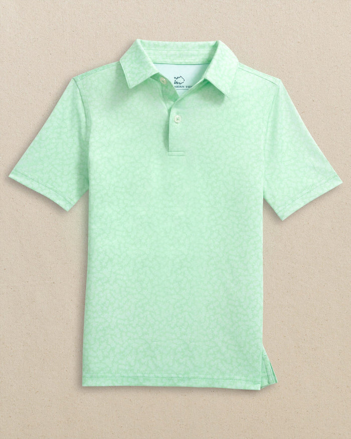 The front view of the Southern Tide Boys Driver Pineapple Parade Printed Performance Polo by Southern Tide - Green Ash