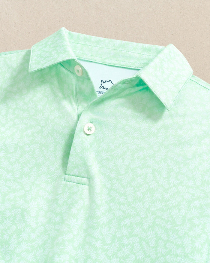 The detail view of the Southern Tide Boys Driver Pineapple Parade Printed Performance Polo by Southern Tide - Green Ash