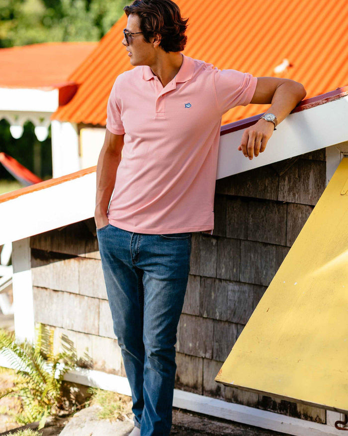 The lifestyle view of the Men's Blue Denim Charleston Denim Jeans by Southern Tide - Medium Wash