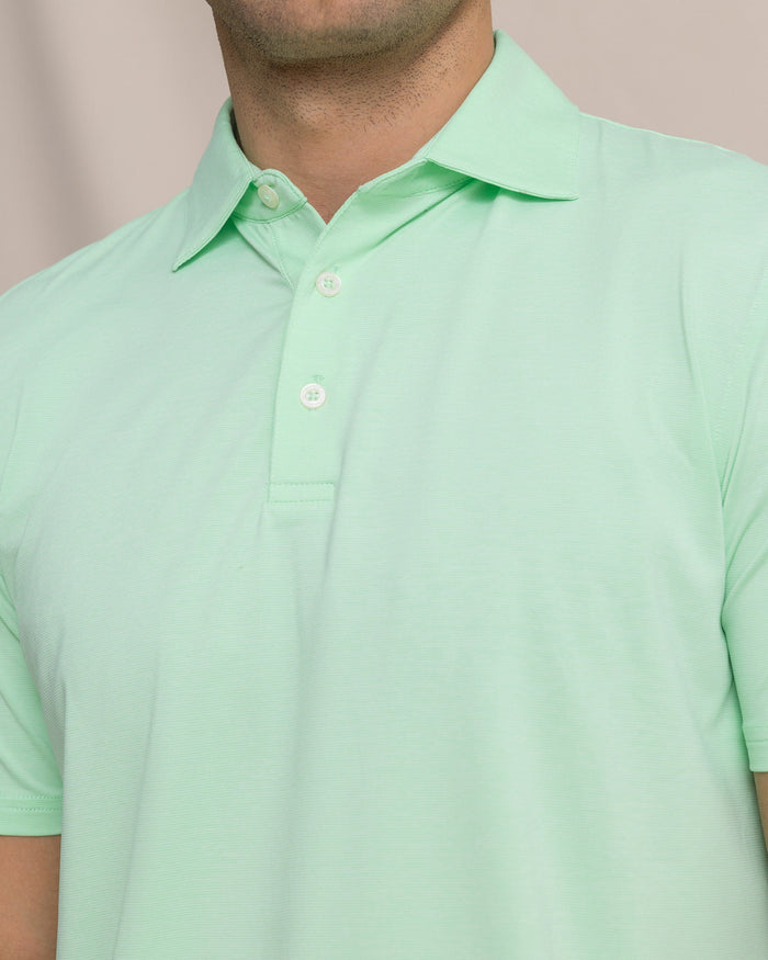 The detail view of the Southern Tide Coastal Breeze® Heather Performance Polo by Southern Tide - Heather Green Ash
