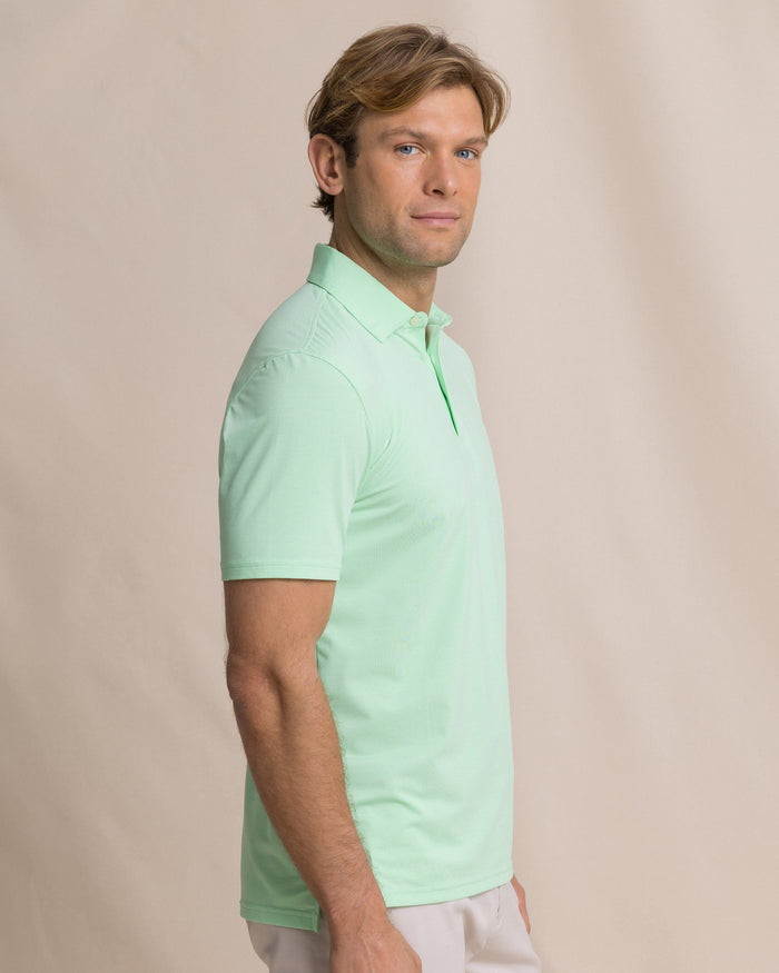The side view of the Southern Tide Coastal Breeze® Heather Performance Polo by Southern Tide - Heather Green Ash
