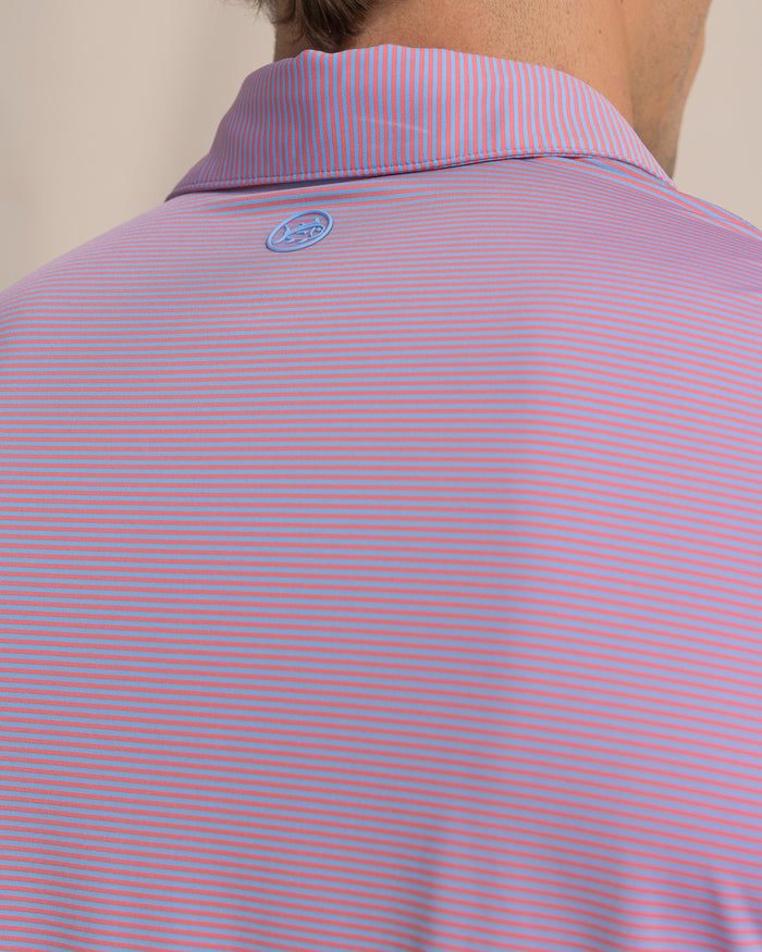 The detail view of the Southern Tide Coastal Breeze® Meadowbrook Stripe Performance Polo by Southern Tide - Coral Beach