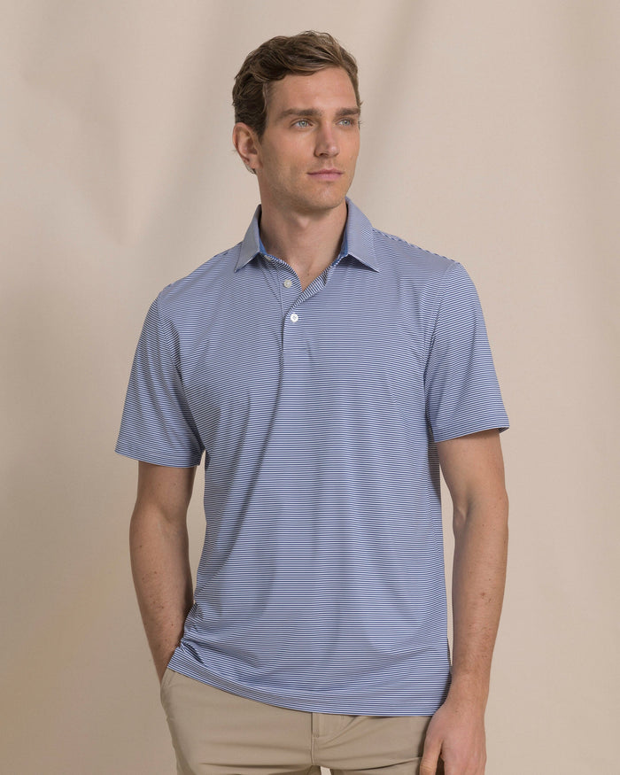 The front view of the Southern Tide Coastal Breeze® Meadowbrook Stripe Performance Polo by Southern Tide - Aged Denim