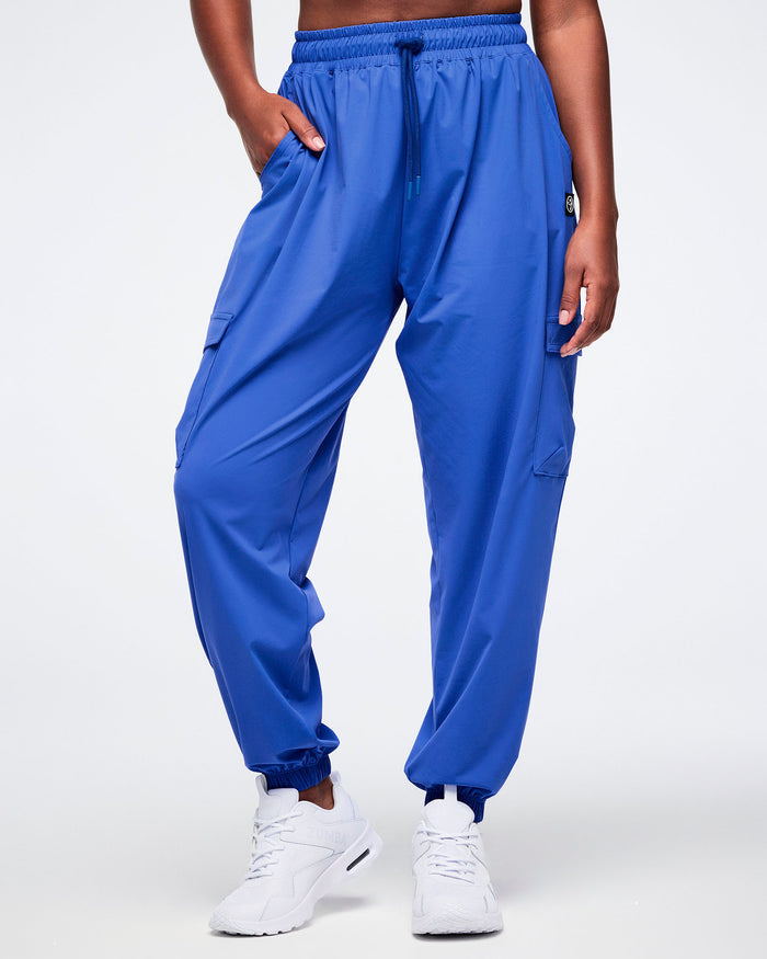 Female model with hand in her right pocket of the Zumba blue cargo pants.