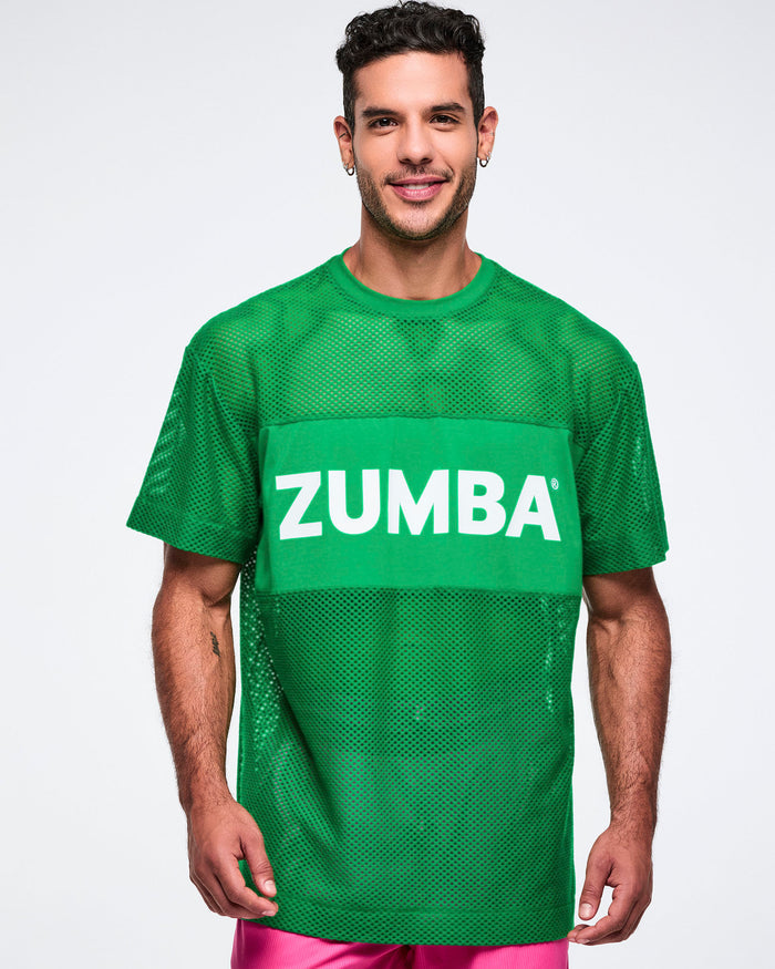Male model wearing a green Zumba green mesh top on a white background.