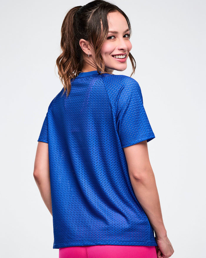 Back view of a blue mesh top modeled on a female model on a white background.