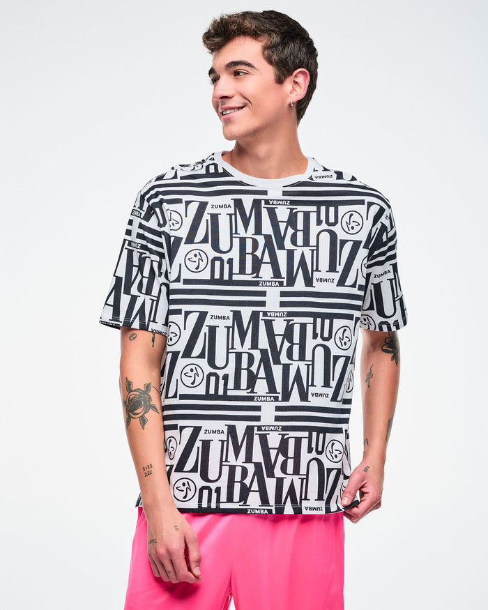 Male model wearing a black and white patterned Zumba boxy top paired with pink pants.