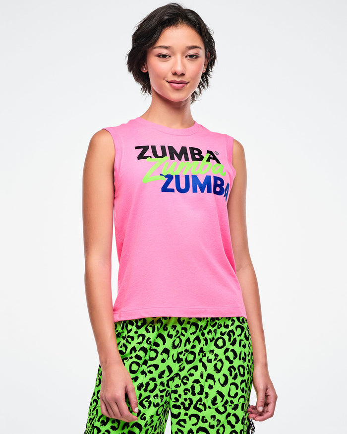 Female model wearing a pink Zumba tank top and green leopard print pants on a white background.