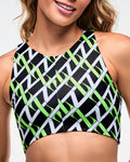 Female model wearing black based crop top with an allover white and green “Z” crisscross pattern.