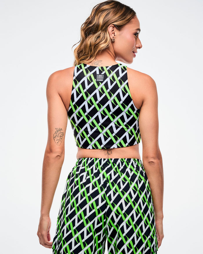 Back view of a female model wearing black based crop top with an allover white and green “Z” crisscross pattern with matching pants.