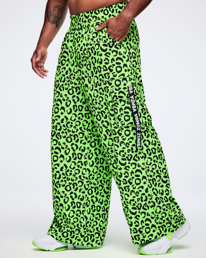 Male model wearing bright green leopard print pants with a visible brand logo on a white background.