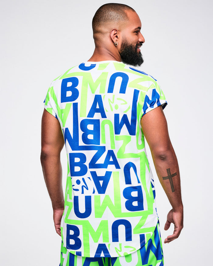 Back view of a male model wearing a colorful t-shirt with "ZUMBA" letter patterns on a plain background.
