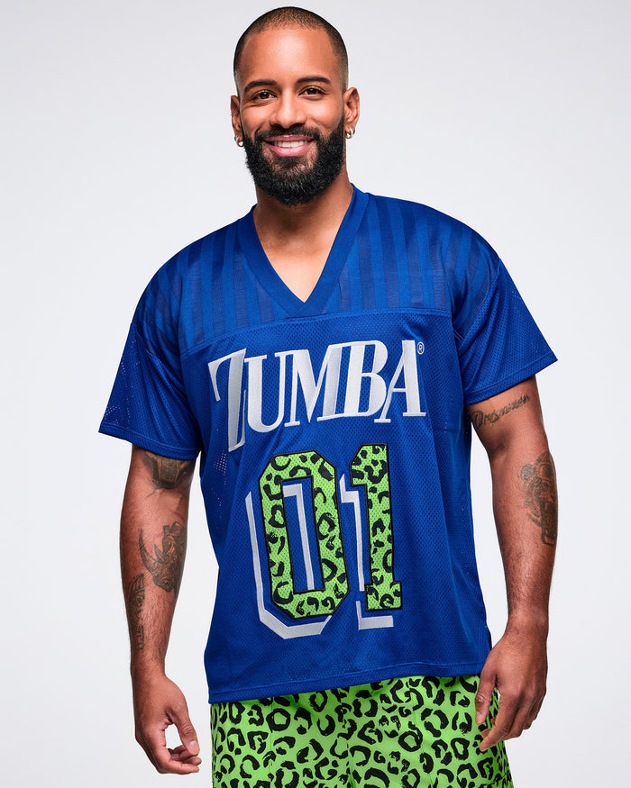 Male model wearing a blue jersey with 'ZUMBA 01' print and paired with green leopard pants.