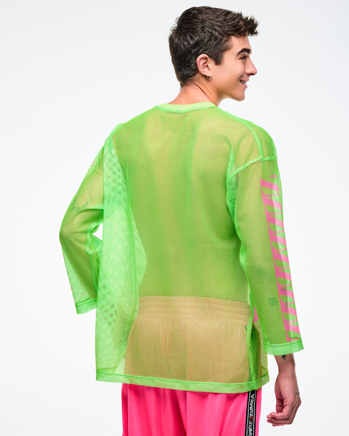 Back view of a male model wearing a neon green mesh long-sleeve Zumba top paired with pink pants.
