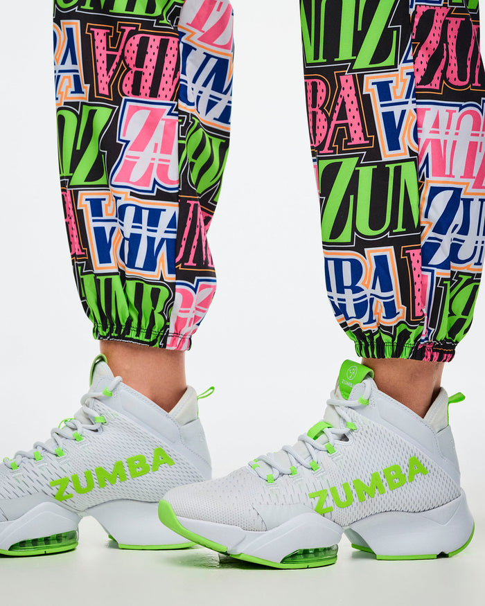 Close-up of encased elastic cuffs on multi-colored Zumba pants, paired with green-and-white shoes.