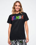 Female model wearing a black Zumba tee with colorful “ZUMBA” text across the chest on a white background.