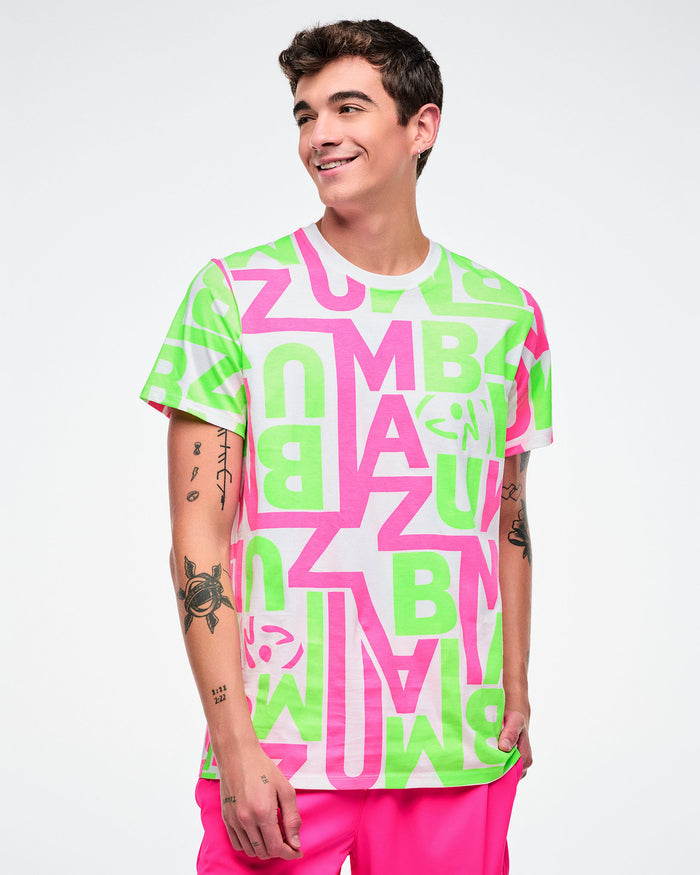 Male model wearing a bright neon green and pink patterned white tee paired with pink pants.