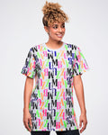 Female model wearing a colorful 'ZUMBA' patterned t-shirt against a white background.