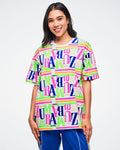 Female model wearing a colorful Zumba t-shirt on a white background.