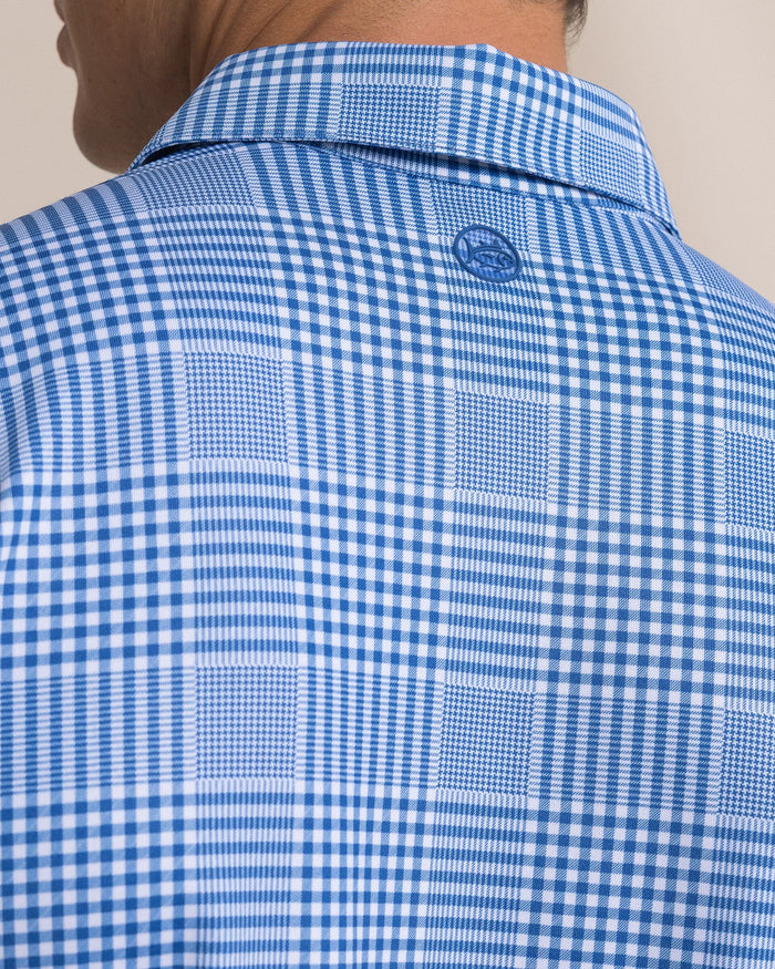 The detail view of the Southern Tide Driver Coral Key Plaid Printed Polo by Southern Tide - Nautical Blue