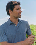 The lifestyle view of the Southern Tide Driver Weaving Around Printed Polo by Southern Tide - Nautical Blue