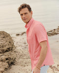 The lifestyle view of the Southern Tide Eastport Heather brrr°® Intercoastal Short Sleeve Sport Shirt by Southern Tide - Sunkist Coral