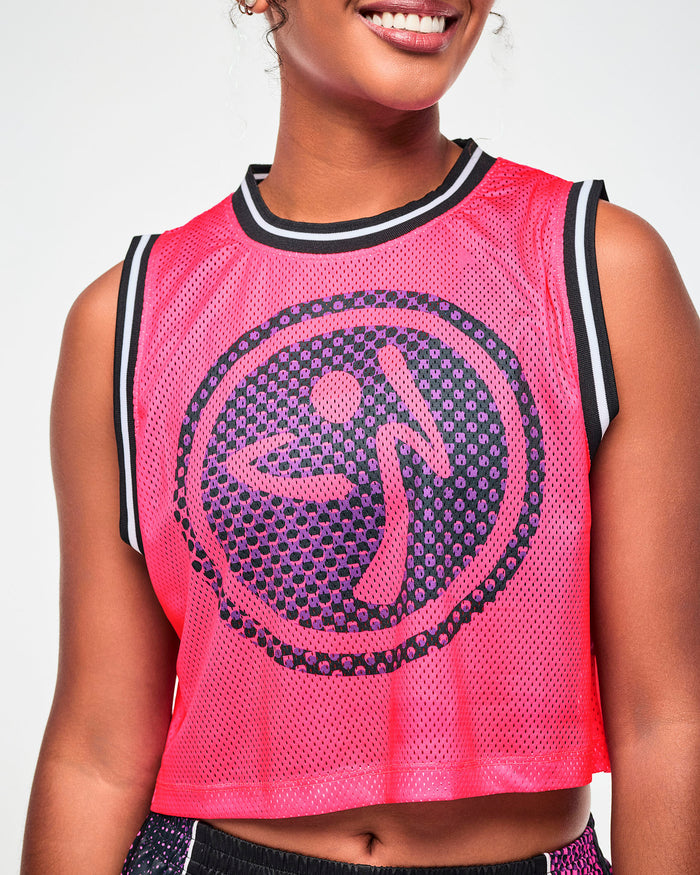 Close-up of a purple and black dot pattern Zumbito logo on a pink mesh tank.