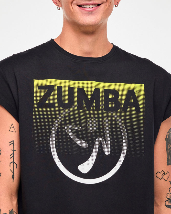 Close-up of a male model wearing a black cap-sleeve tee with a yellow-to-white gradient "ZUMBA" logo and Zumbito graphic.