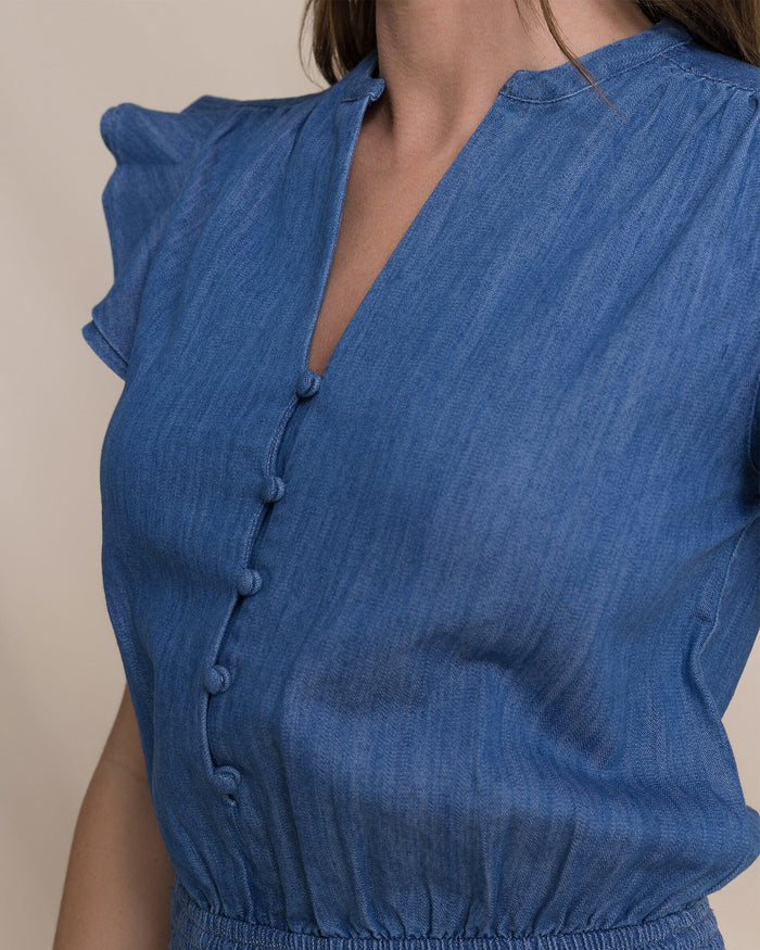 The detail view of the Southern Tide Evalyn Flutter Sleeve Smocked Romper by Southern Tide - Medium Wash Indigo