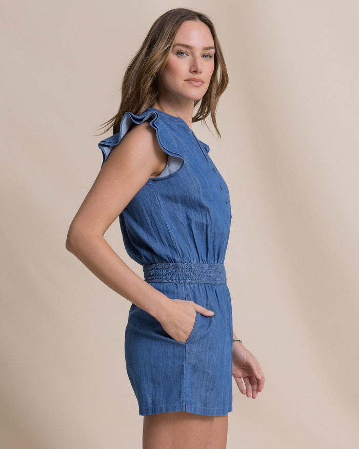 The side view of the Southern Tide Evalyn Flutter Sleeve Smocked Romper by Southern Tide - Medium Wash Indigo