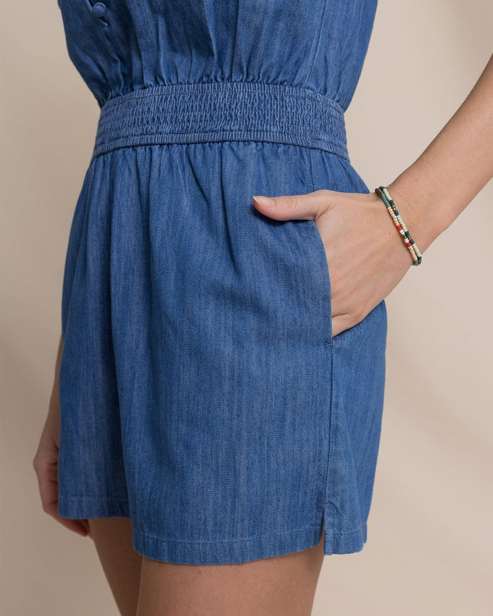 The detail view of the Southern Tide Evalyn Flutter Sleeve Smocked Romper by Southern Tide - Medium Wash Indigo