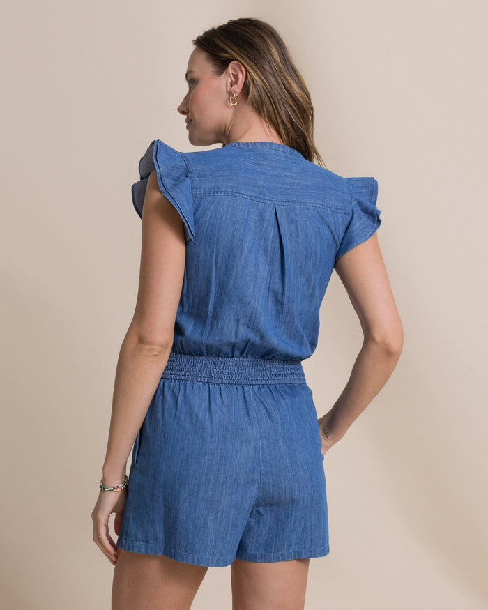 The back view of the Southern Tide Evalyn Flutter Sleeve Smocked Romper by Southern Tide - Medium Wash Indigo