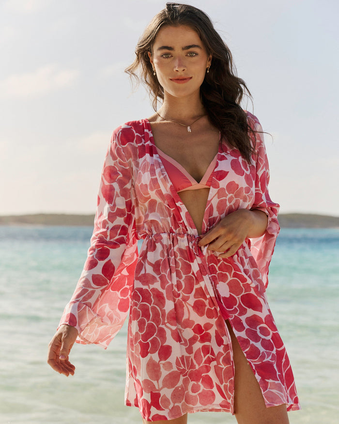 The front lifestyle view of the Southern Tide Floral Bell Sleeve Short Tunic Cover-Up by Southern Tide - Island Pink