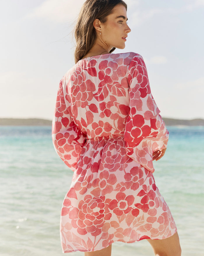 The back lifestyle view of the Southern Tide Floral Bell Sleeve Short Tunic Cover-Up by Southern Tide - Island Pink