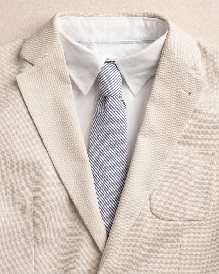 The detail coat view of the Southern Tide Blue and White Seersucker Necktie by Southern Tide - Blue
