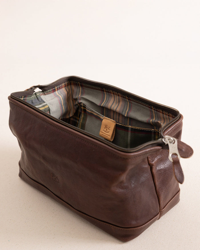 The side view of the Il Bisonte Travel Bag at Southern Tide - Coffee