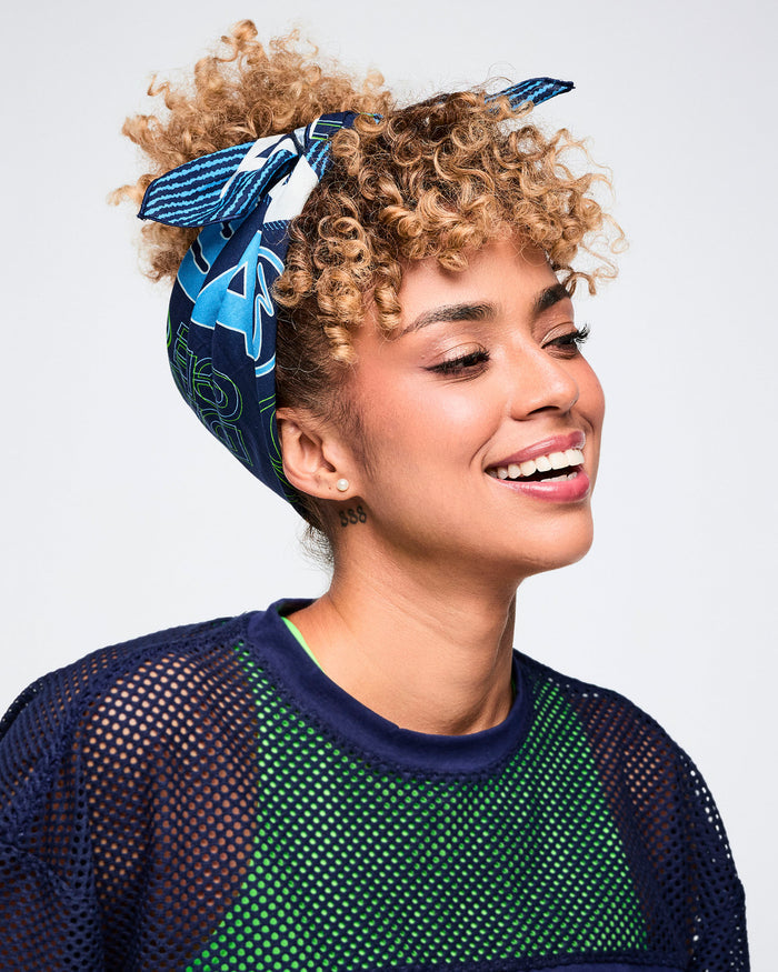 Female model styling a blue bandana as a headscarf.