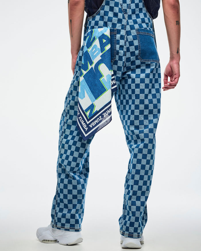 Male model in blue checkered overalls with a colorful patterned bandana hanging out of the back-left pocket.