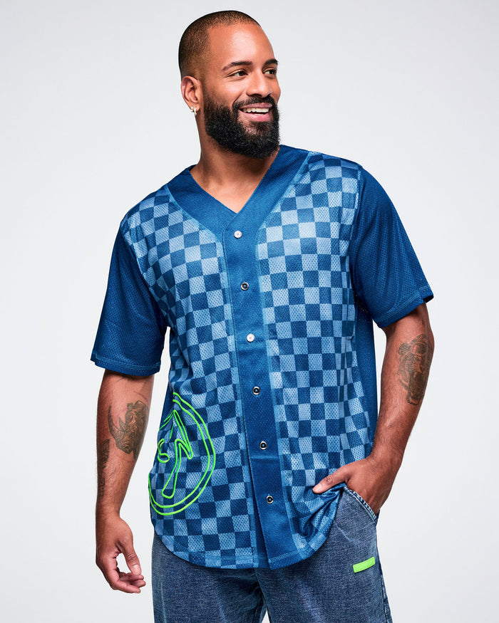 Male model wearing a blue checkered button-up jersey with a green Zumbito logo on a white background.