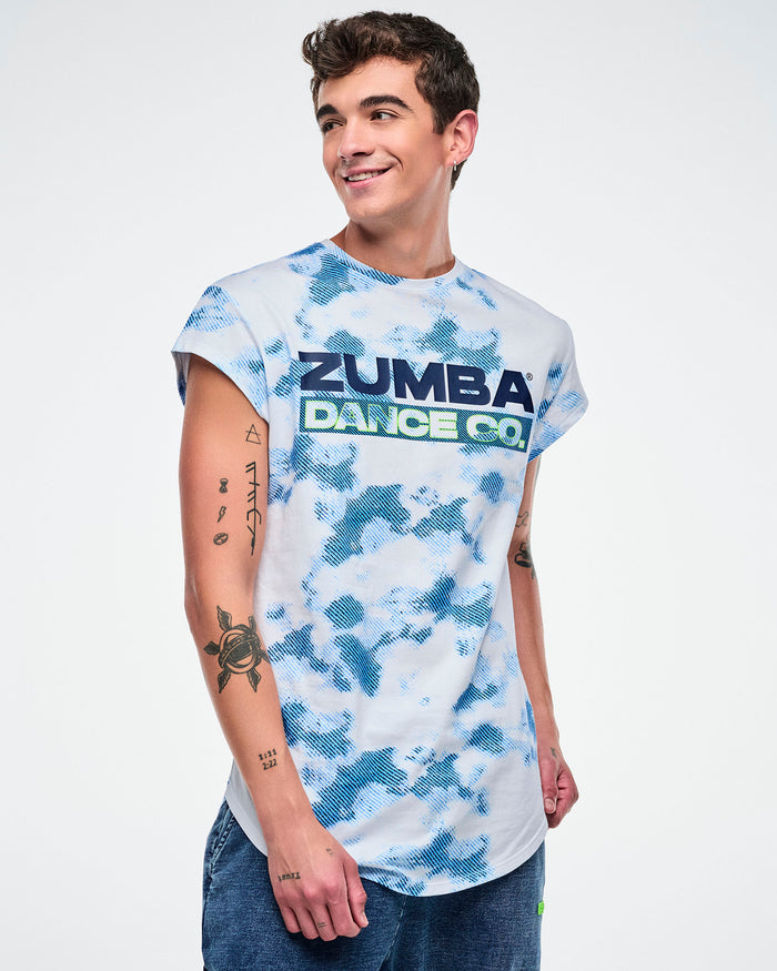 Male model wearing a Zumba Dance Co t-shirt with a blue and white pattern on a plain background.